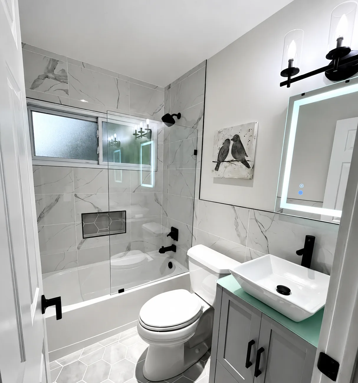 Bathroom remodel with marble tile shower surround, matte black fixtures, and floating vanity by DMV Home Improvement LLC in Washington, D.C.