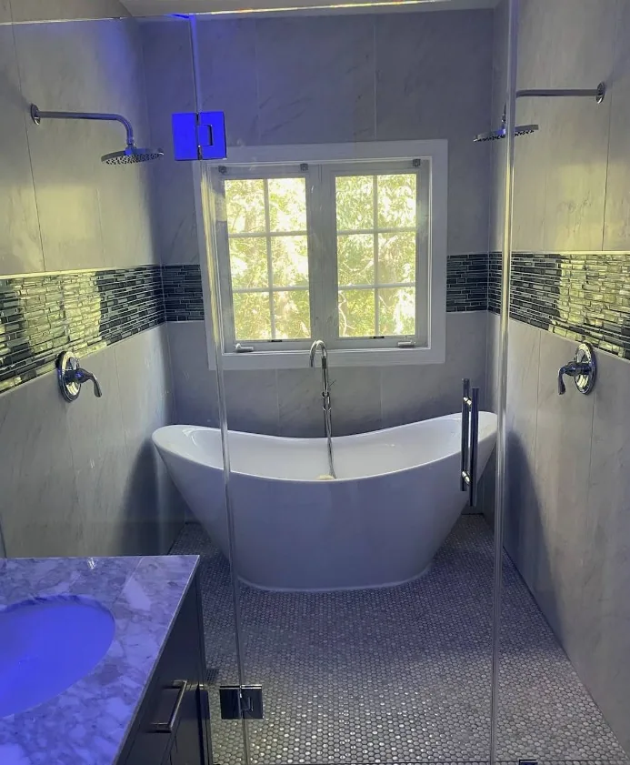 Spa-inspired bathroom with freestanding tub and dual rain showers