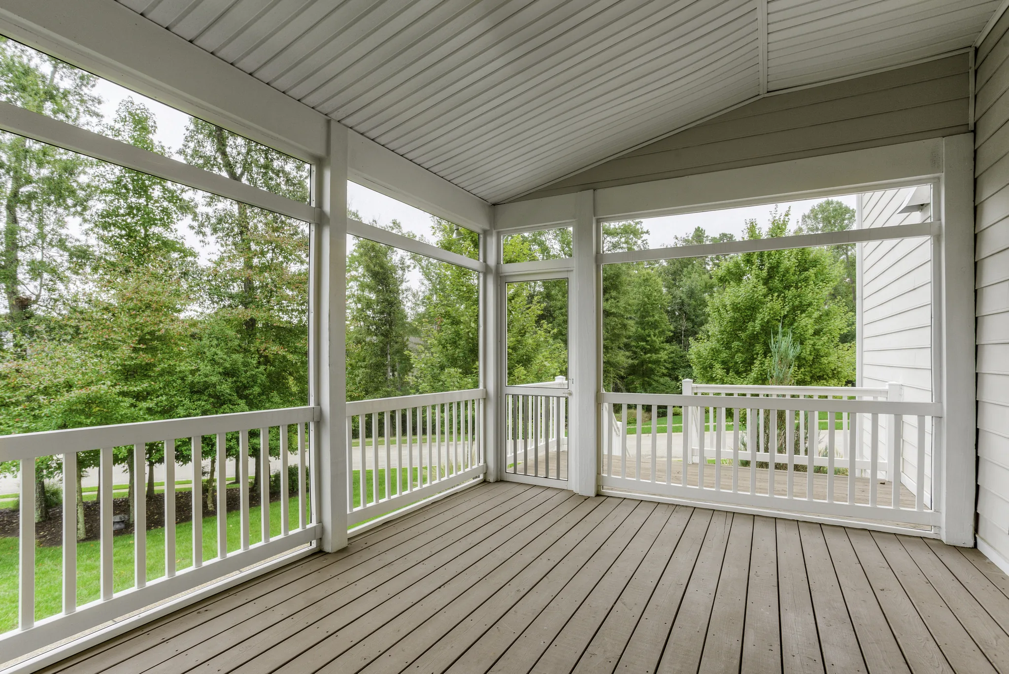 Screened-in porch deck with white railings