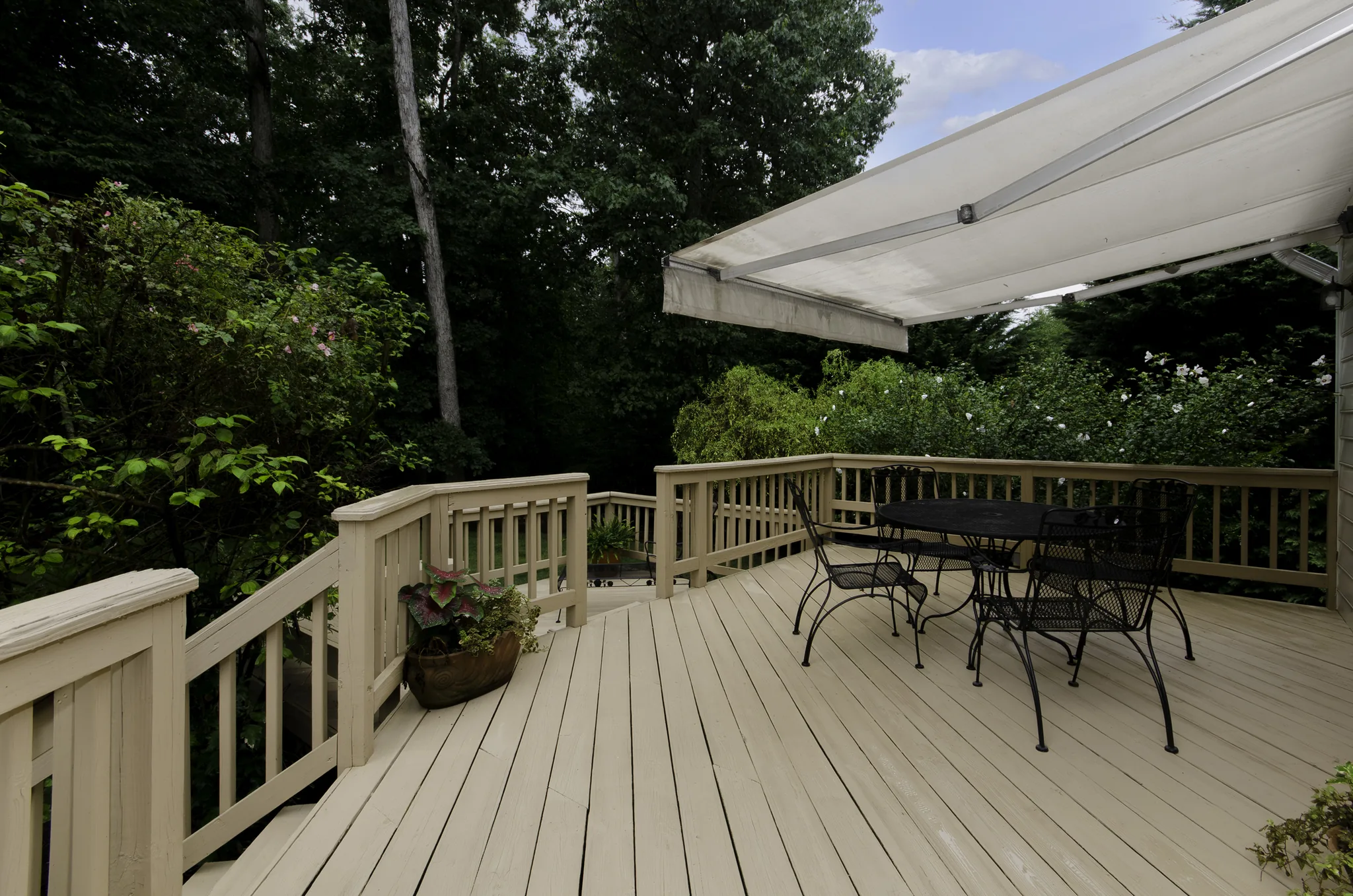 Composite deck with awning and outdoor dining area