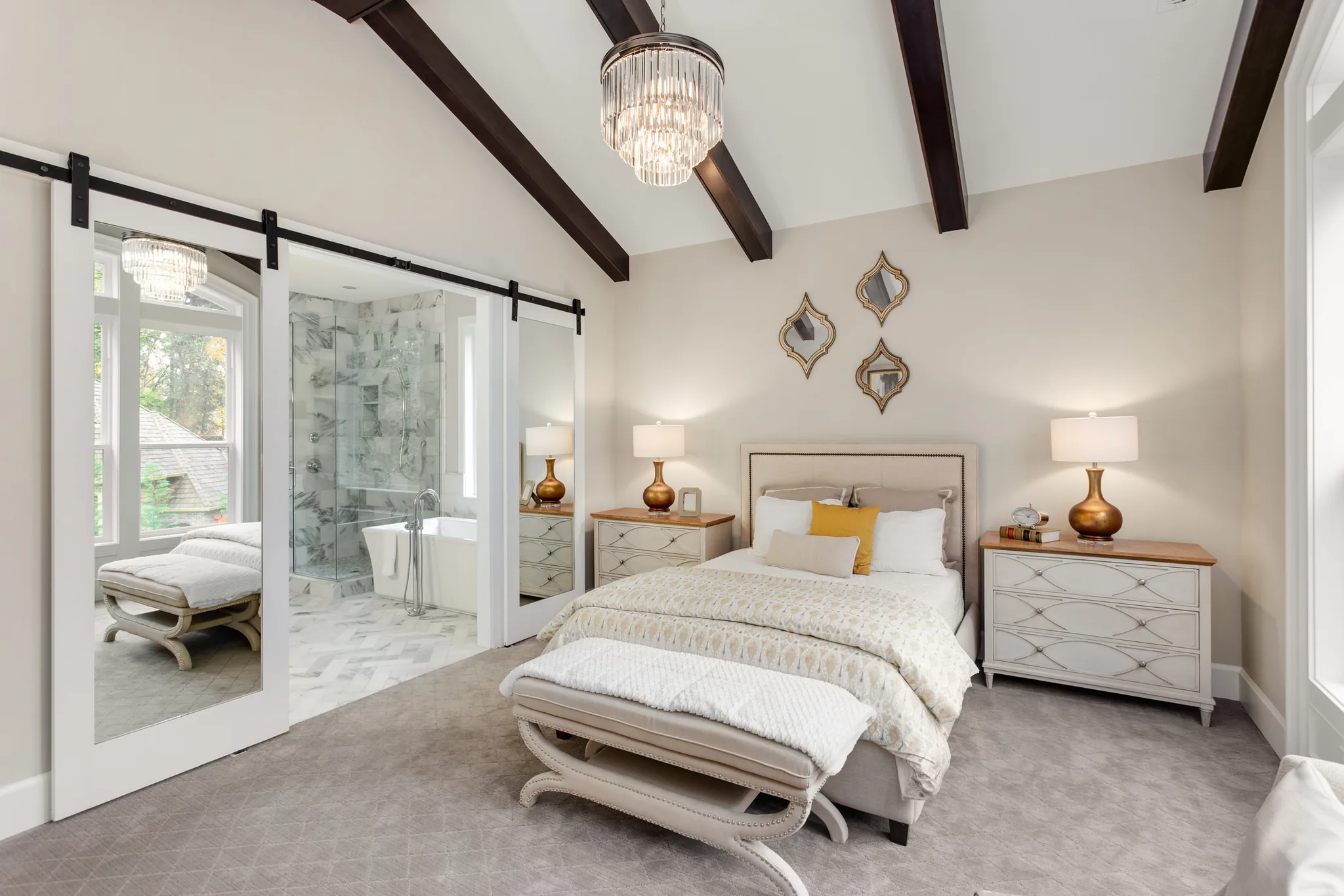 Luxury basement master suite with barn doors and vaulted ceiling