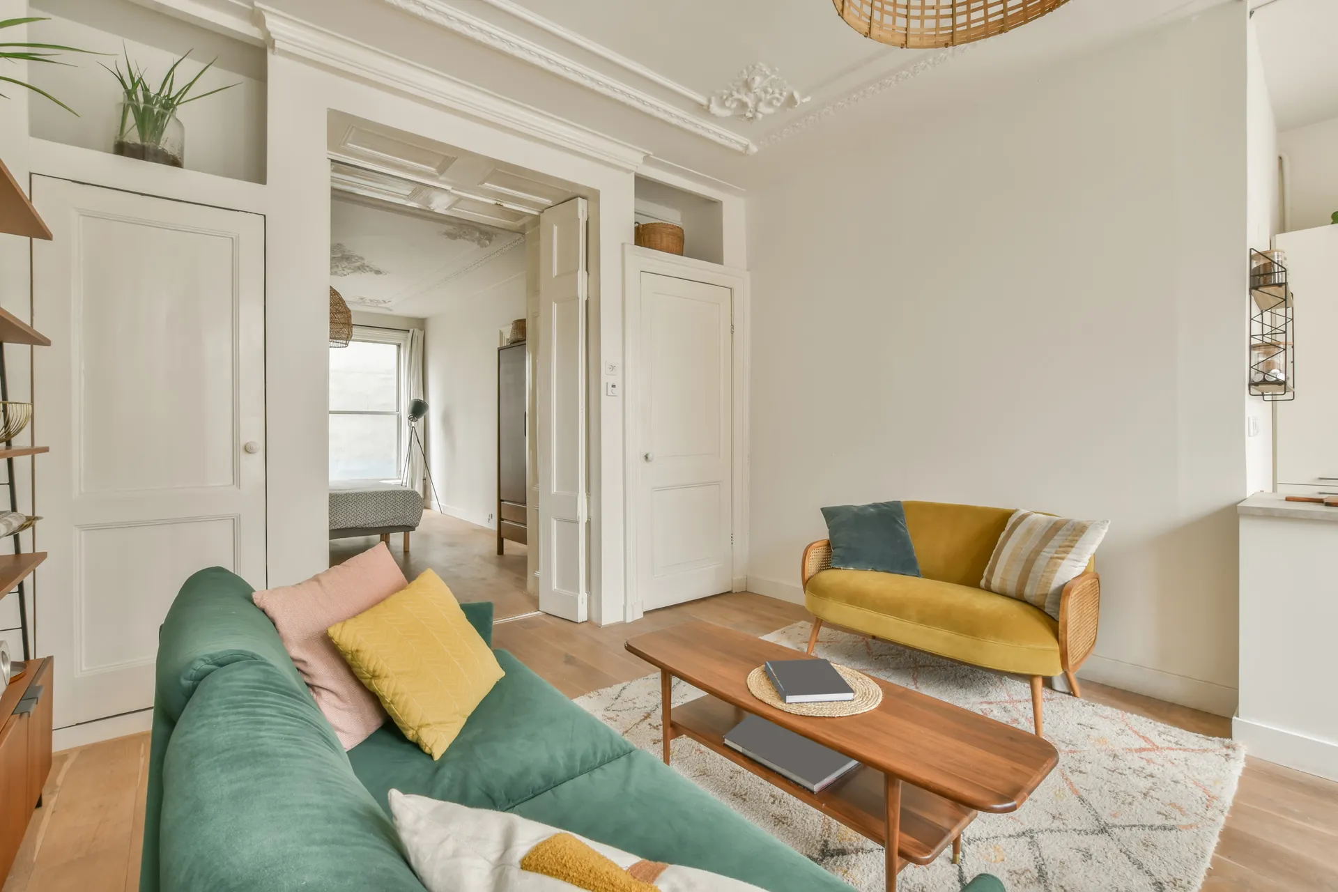 Living room in an older house with built-in shelving, painted trim and interior doors