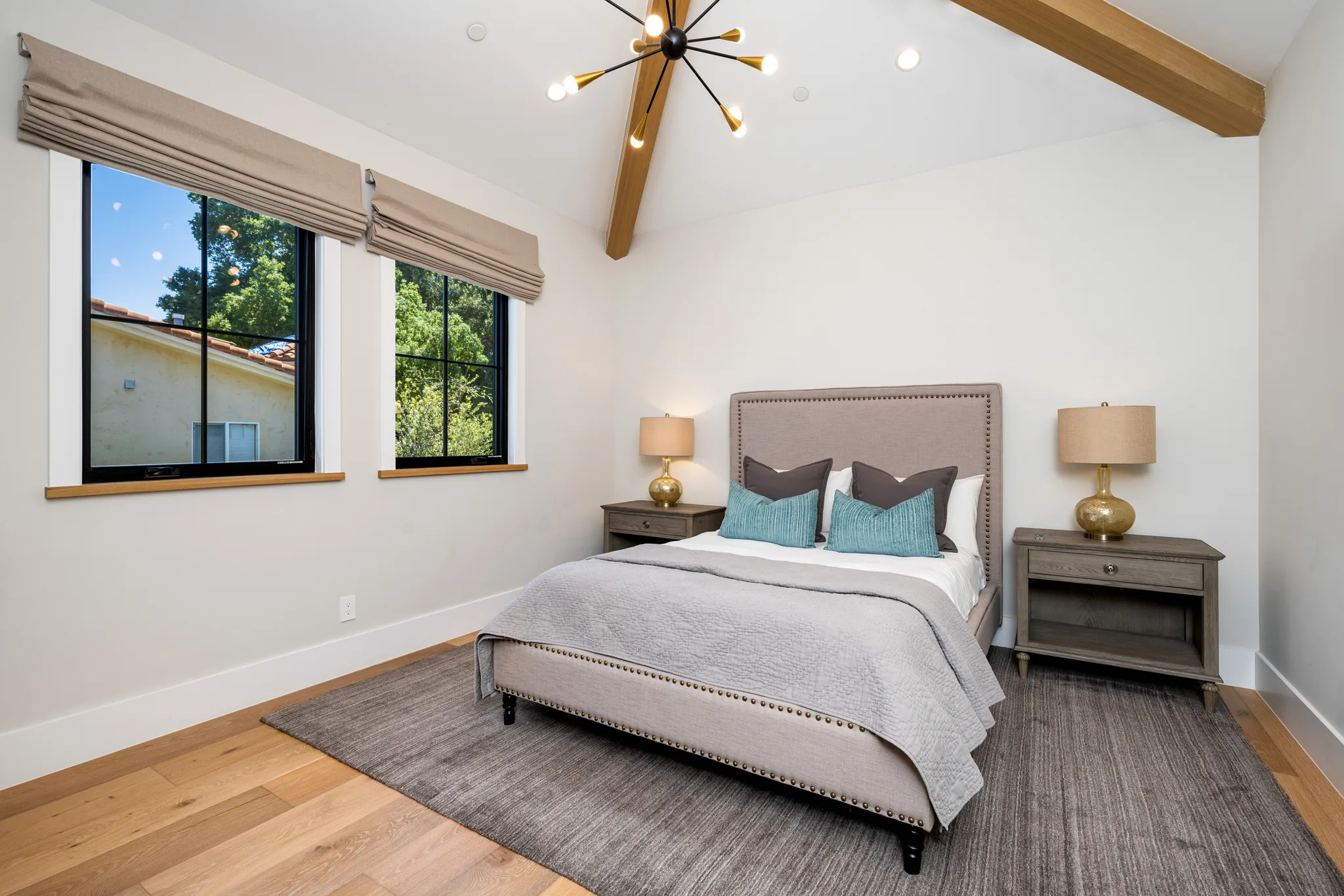 Basement bedroom with exposed beam and modern fixtures
