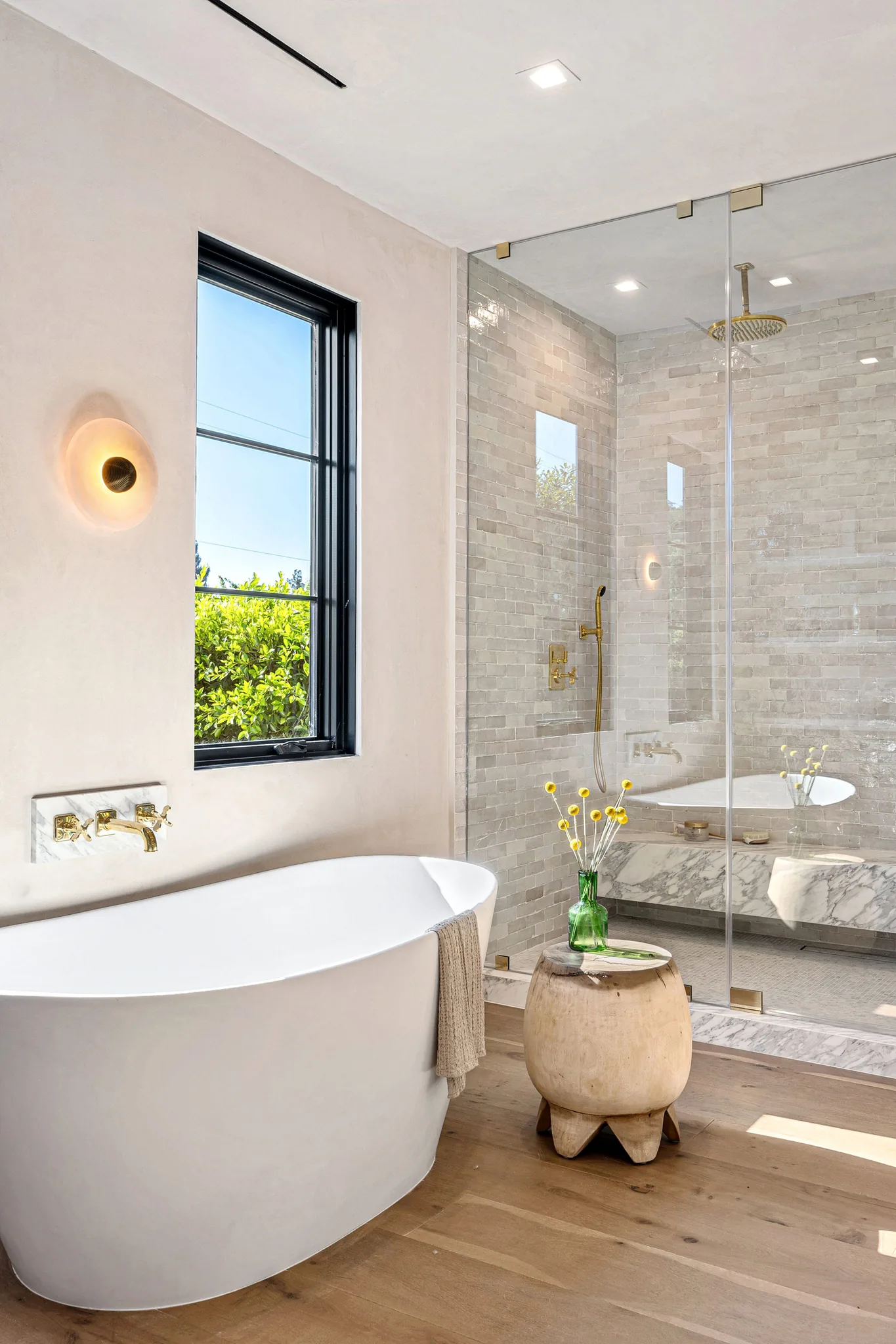 Luxury bathroom with freestanding soaking tub and walk-in glass shower