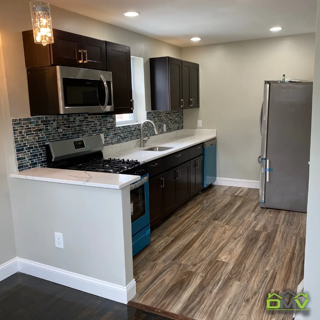 Kitchen remodel with dark espresso cabinets and teal glass tile backsplash