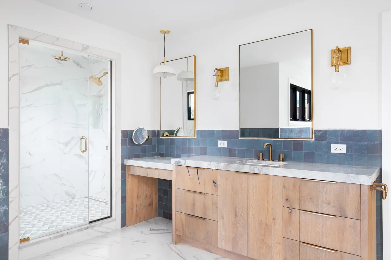 Blue tile bathroom with gold fixtures
