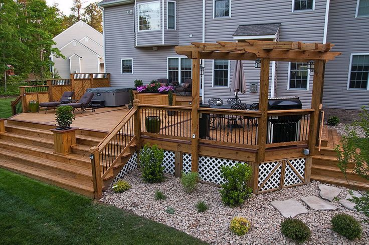 Deck buildout using brown deck boards and pergola addition.